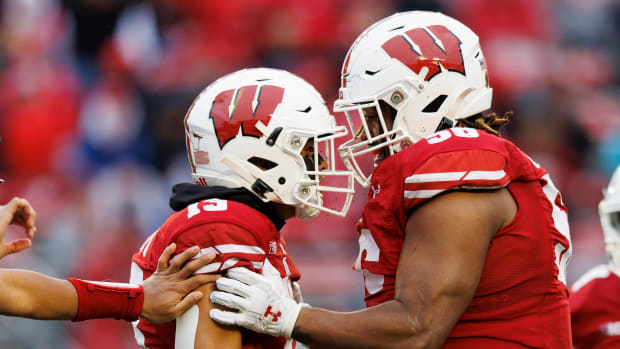 Wisconsin defensive players Rodas Johnson and Kamo'i Latu celebrate a big hit against Maryland.